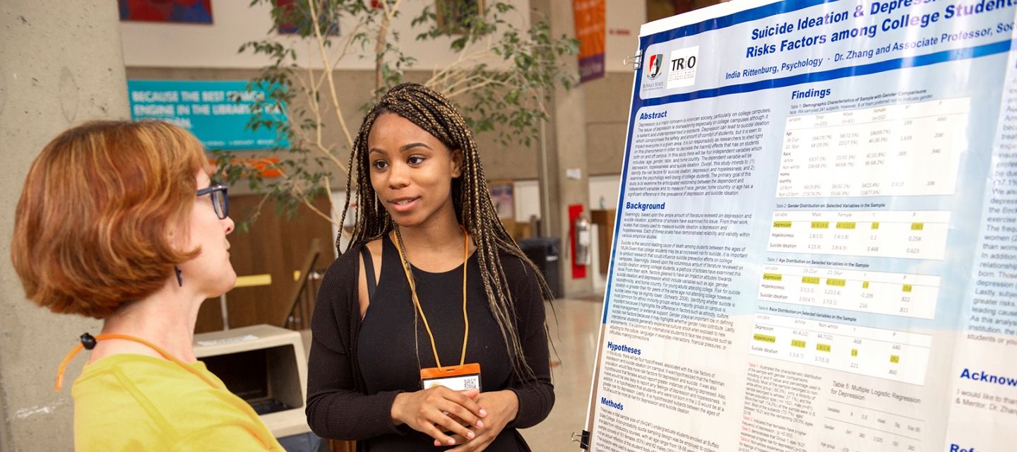 Student and faculty at a poster presentation